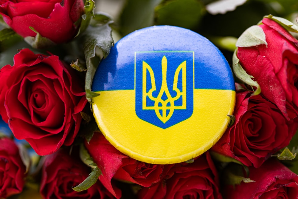 a bouquet of red roses with a badge on it