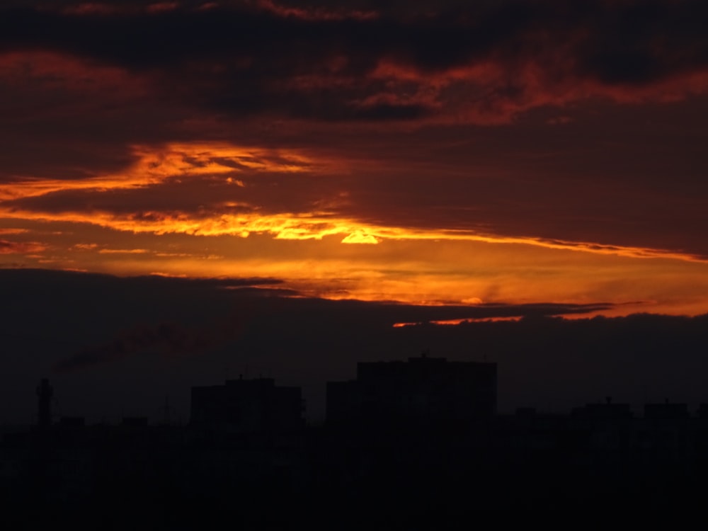 the sun is setting over a city skyline