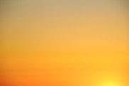 the sun is setting over the horizon of a body of water