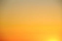 the sun is setting over the horizon of a body of water