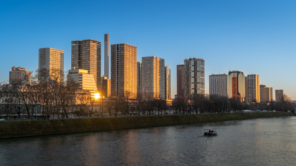 a boat on a river in front of a city