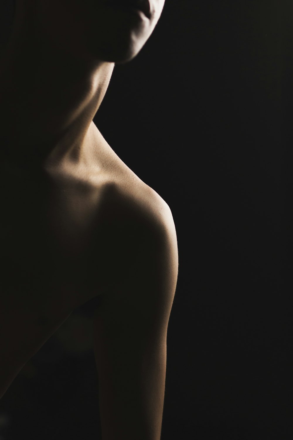 a naked woman with a black background