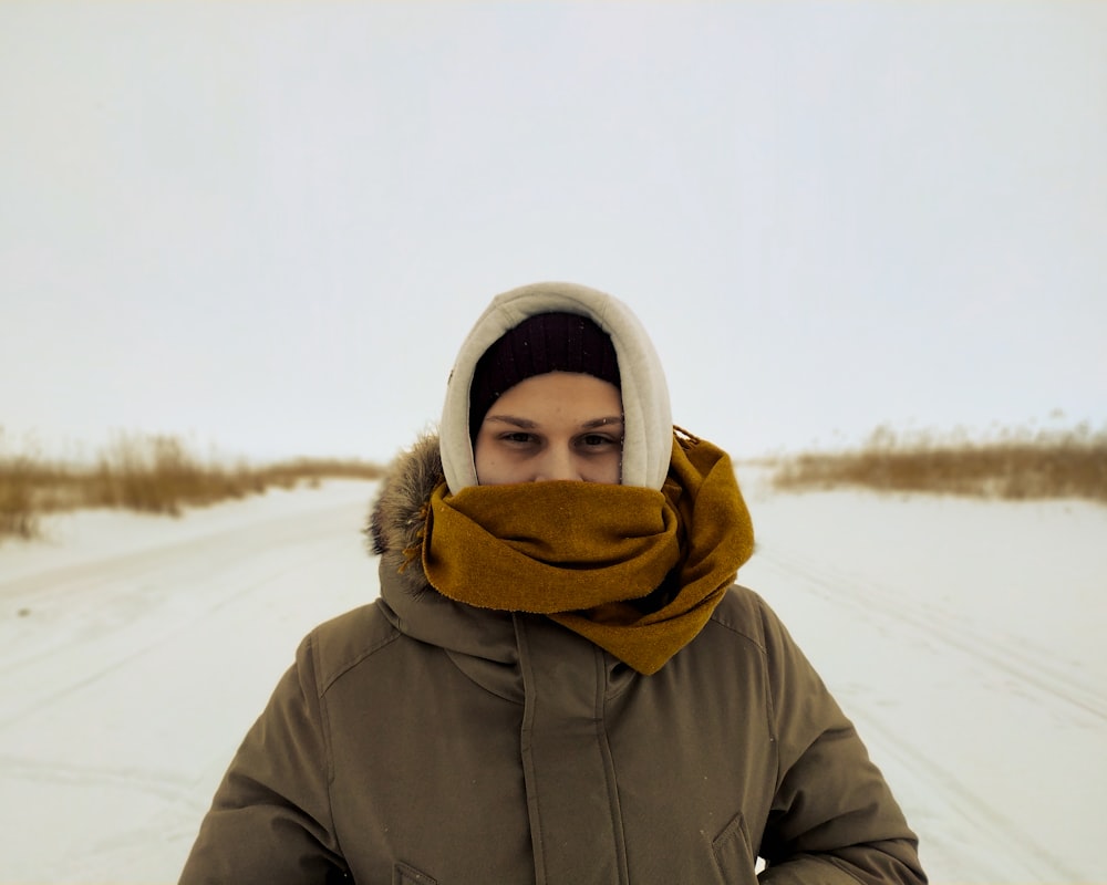 a woman with a scarf around her head in the snow