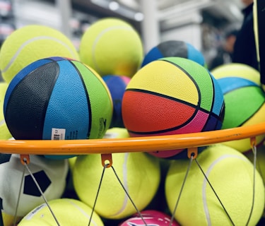 a pile of tennis balls sitting on top of a rack