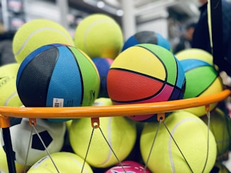 a pile of tennis balls sitting on top of a rack