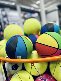 a basket full of colorful balls in a store