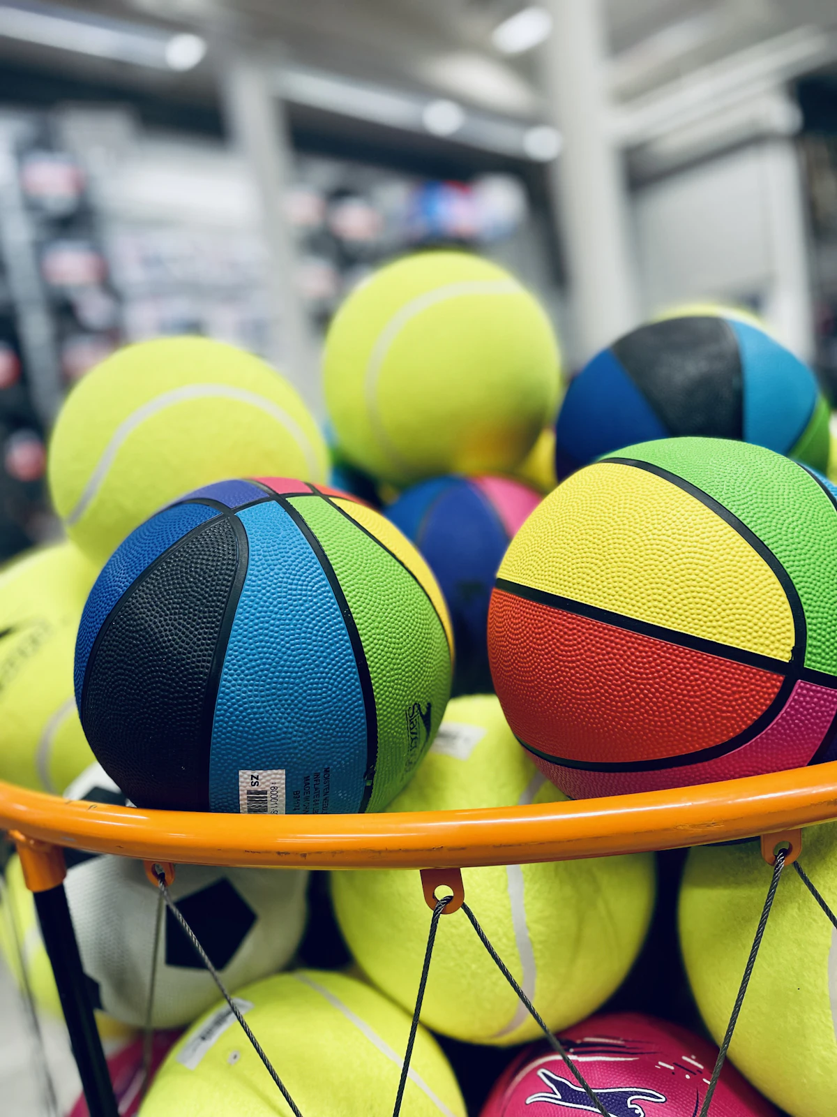 Cesto com bolas esportivas variadas