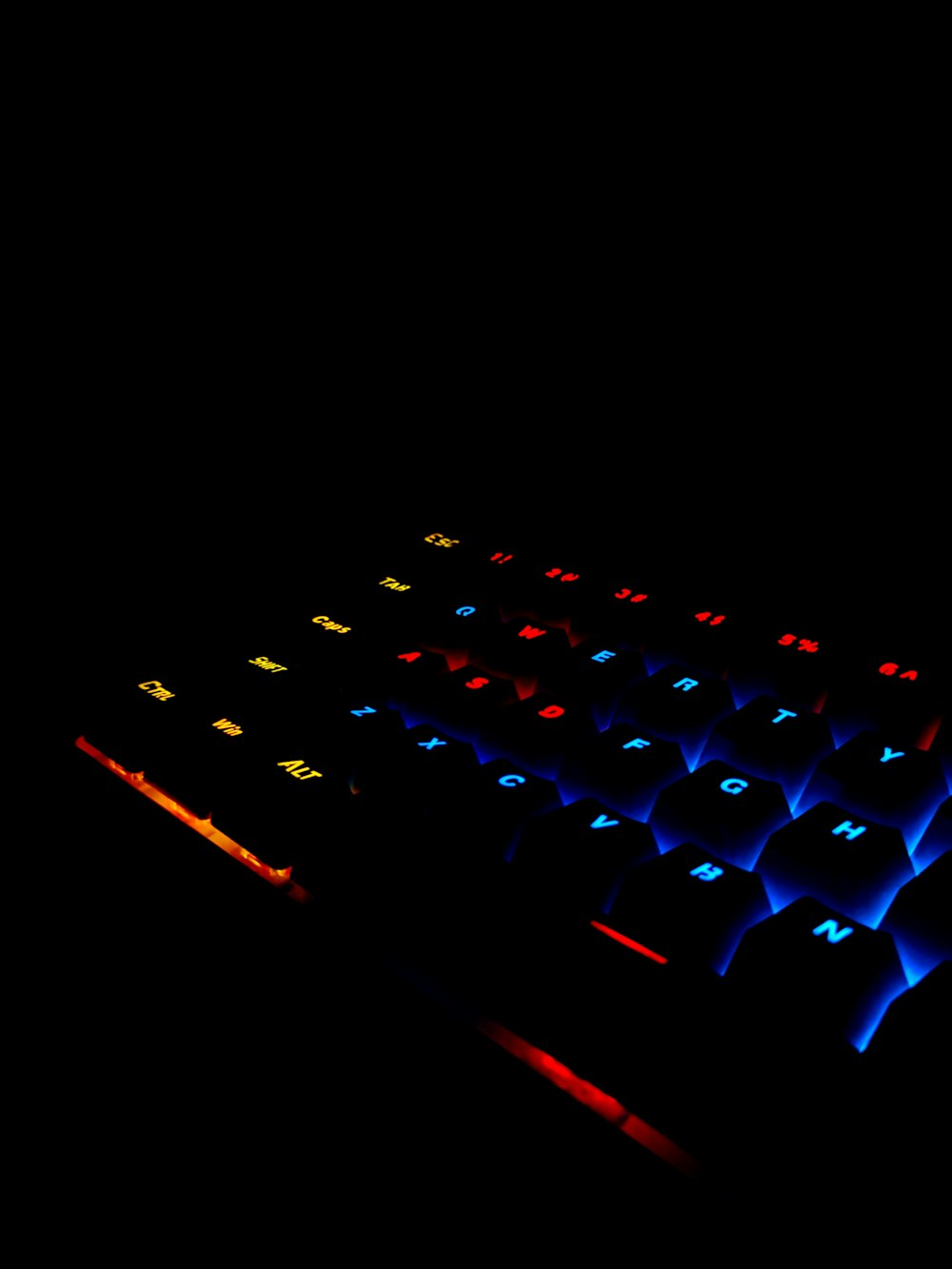 a computer keyboard lit up in the dark