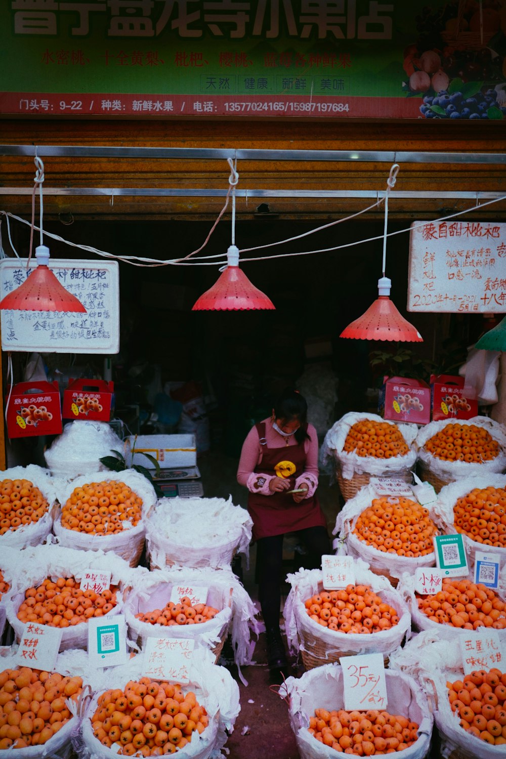 a woman standing in front of a bunch of bags of food