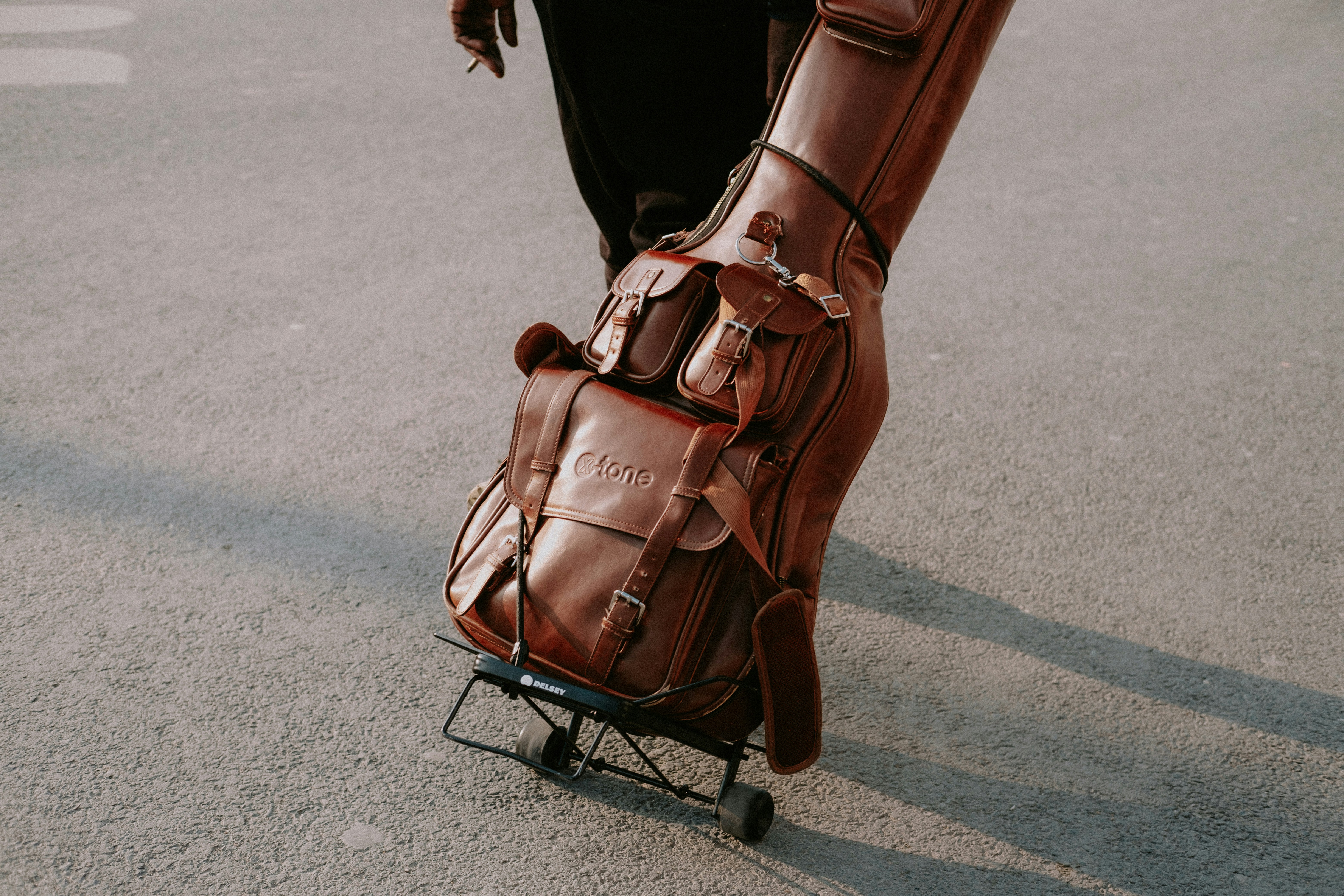 A person pushing a luggage cart at an airport