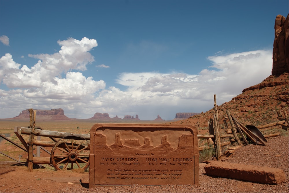 a sign on the side of a dirt road