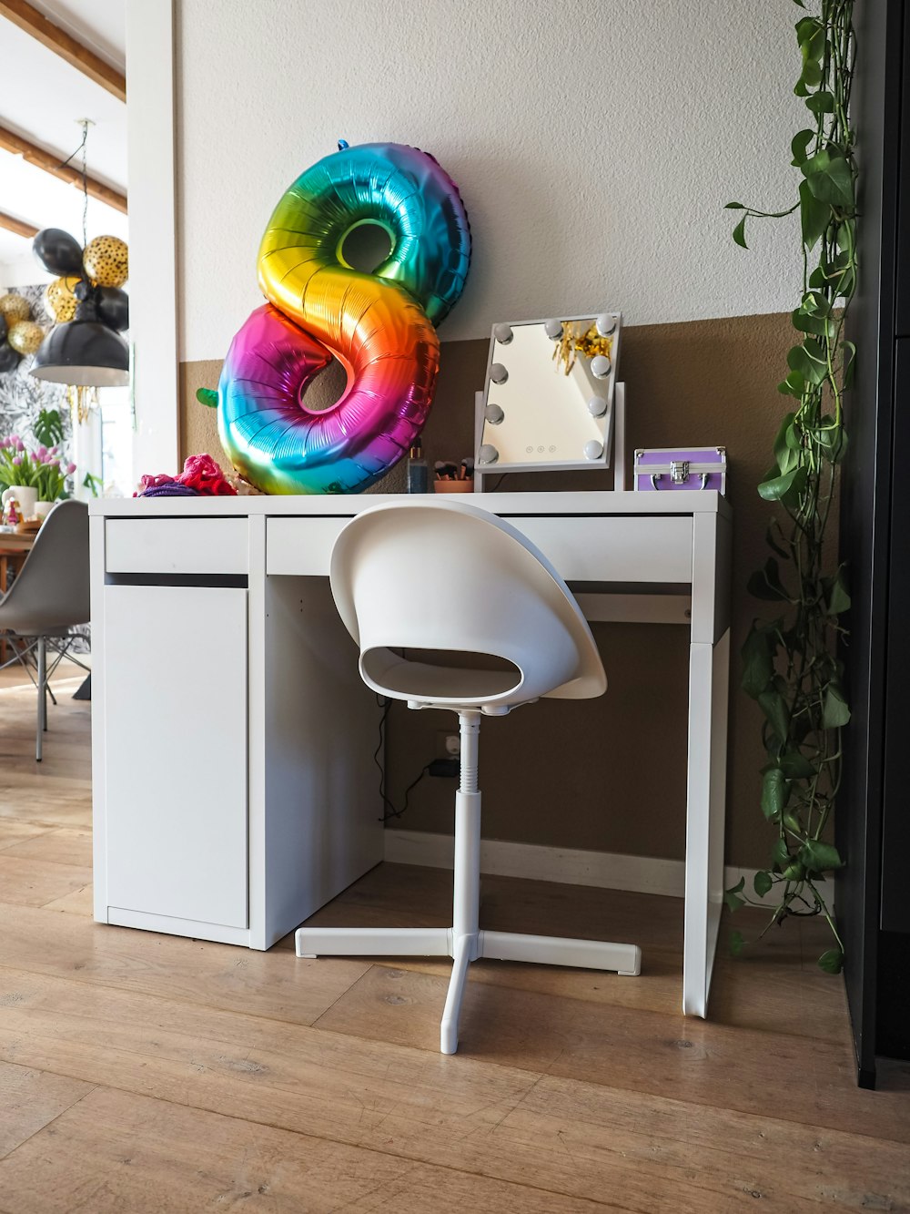 a desk with a computer and a chair in a room