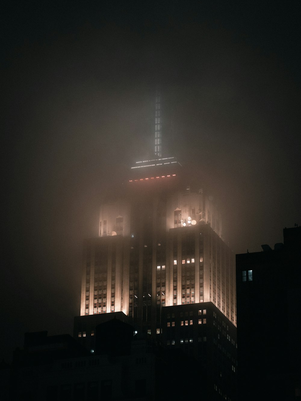 a very tall building with some lights on top of it