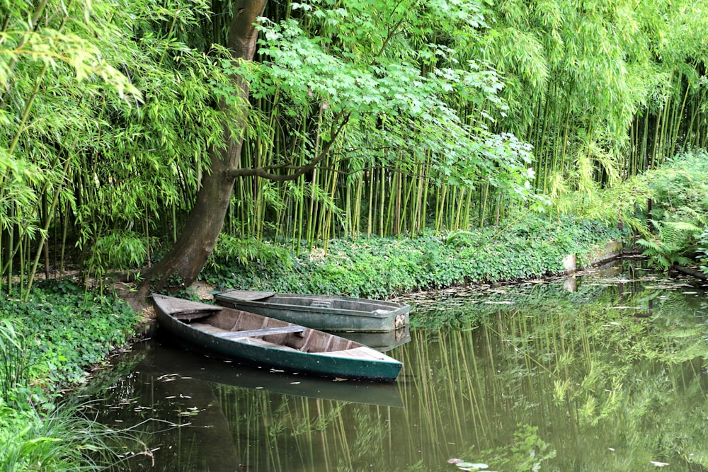 a couple of small boats floating on top of a river