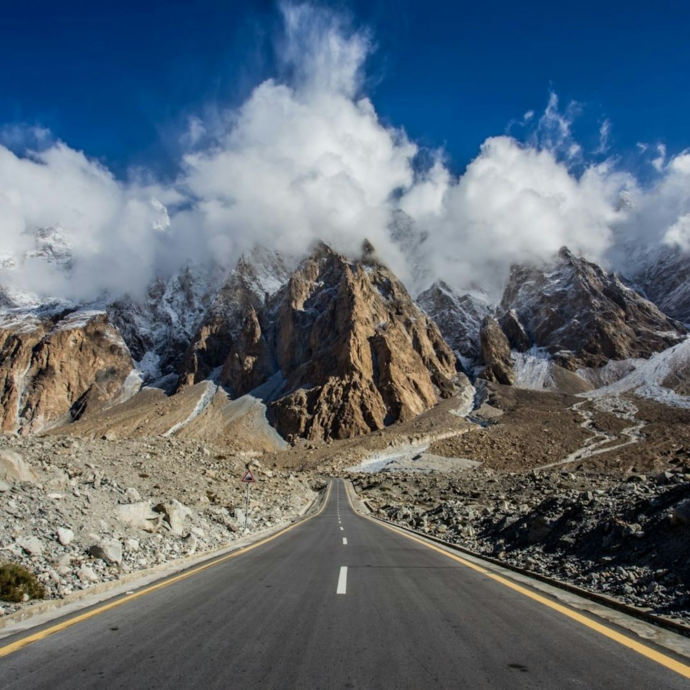 a long road with a mountain in the background