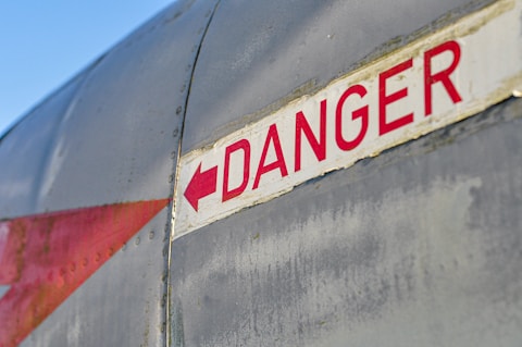 a red and white sign that says danger on it