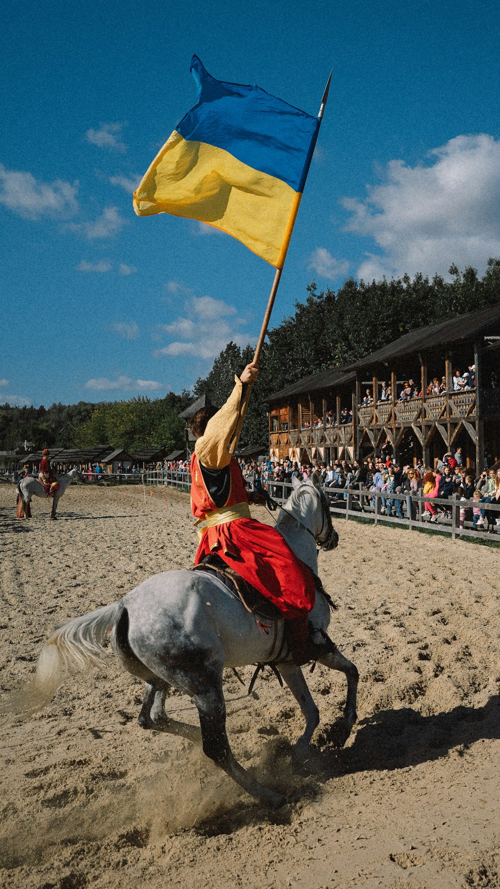 a man riding a horse holding a flag