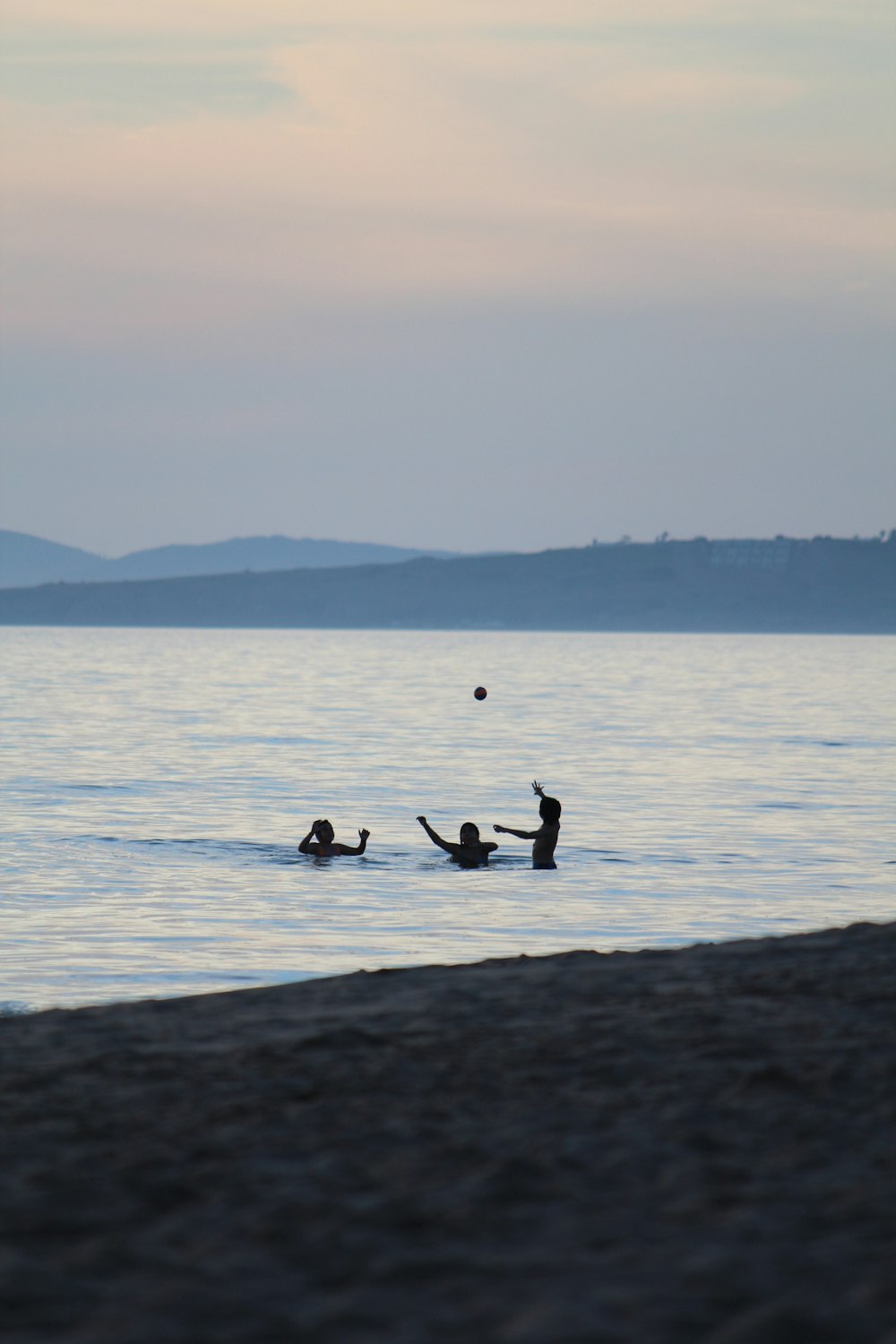 a group of people swimming in a body of water