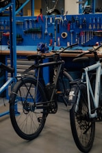 a bicycle parked in front of a blue work bench