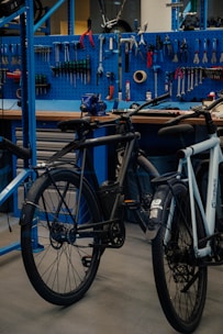 a bicycle parked in front of a blue work bench