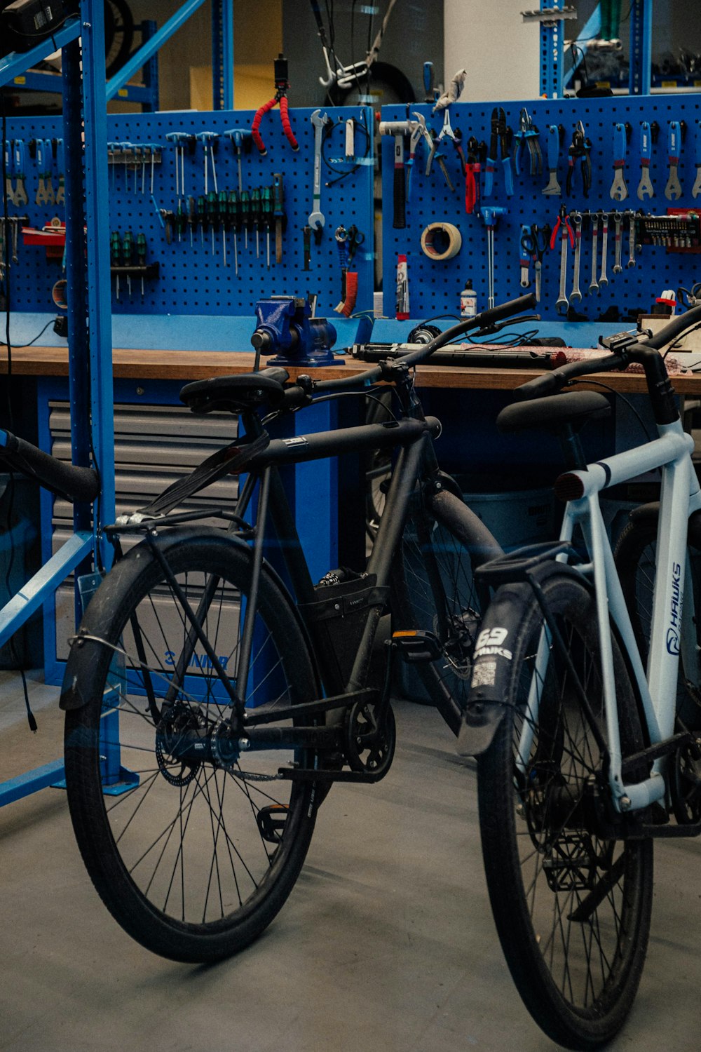 a bicycle parked in front of a blue work bench