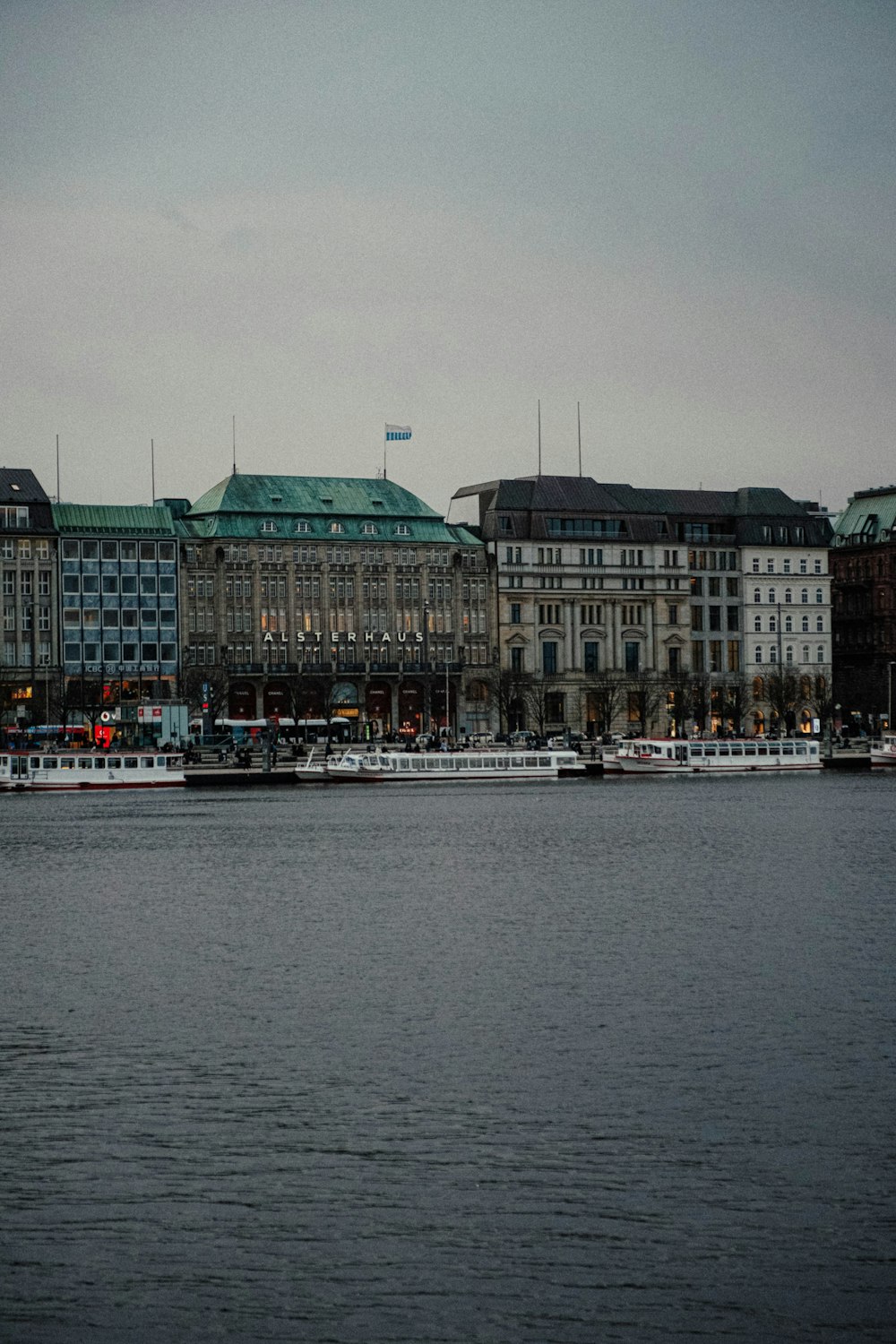 a large body of water with buildings in the background