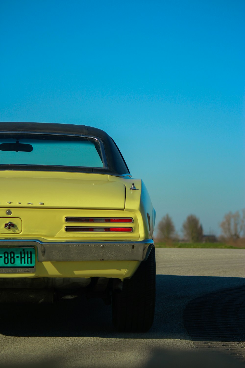 a yellow car parked on the side of the road