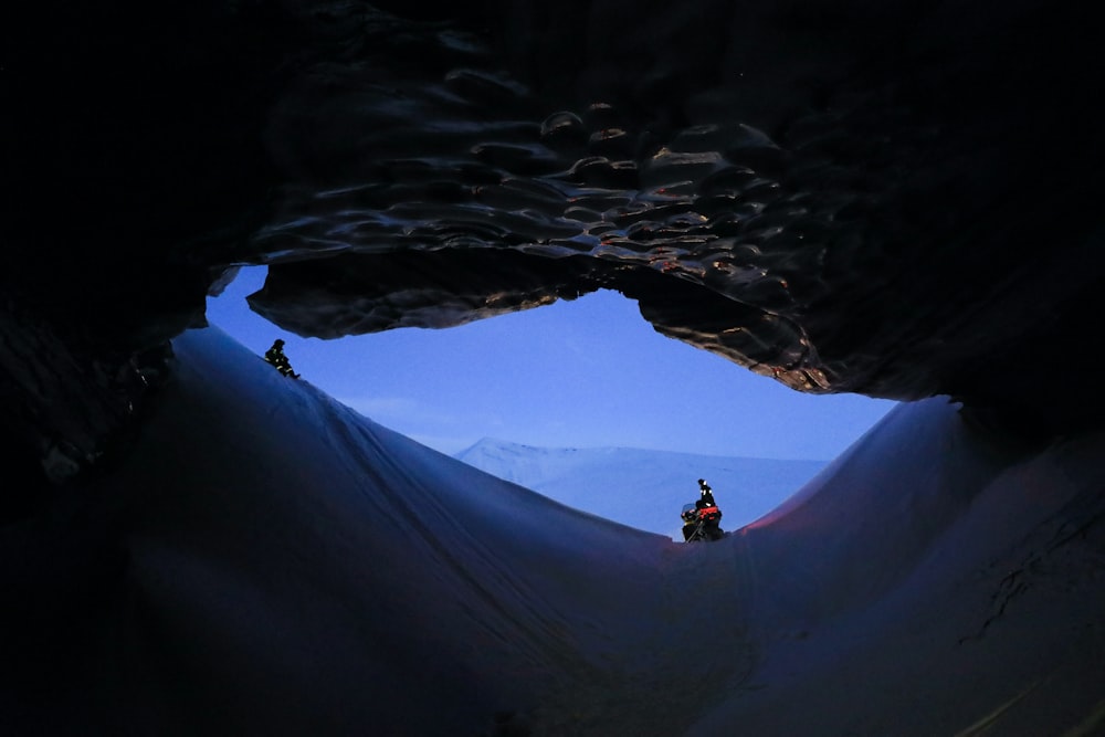 a group of people riding motorcycles through a cave