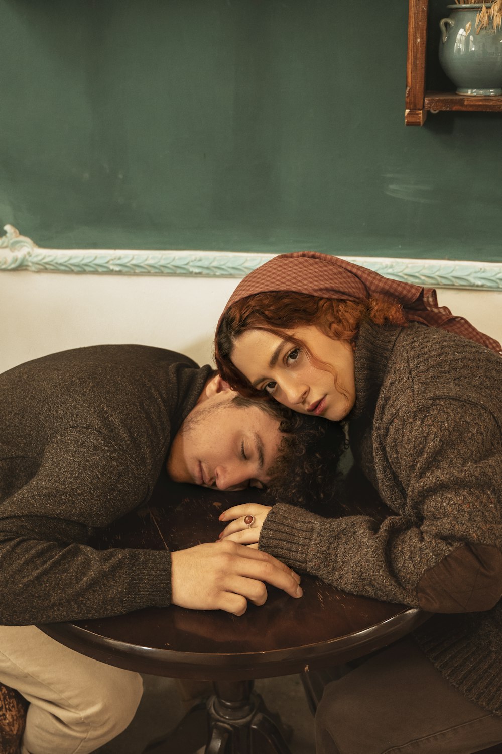 a man and a woman laying on top of a table
