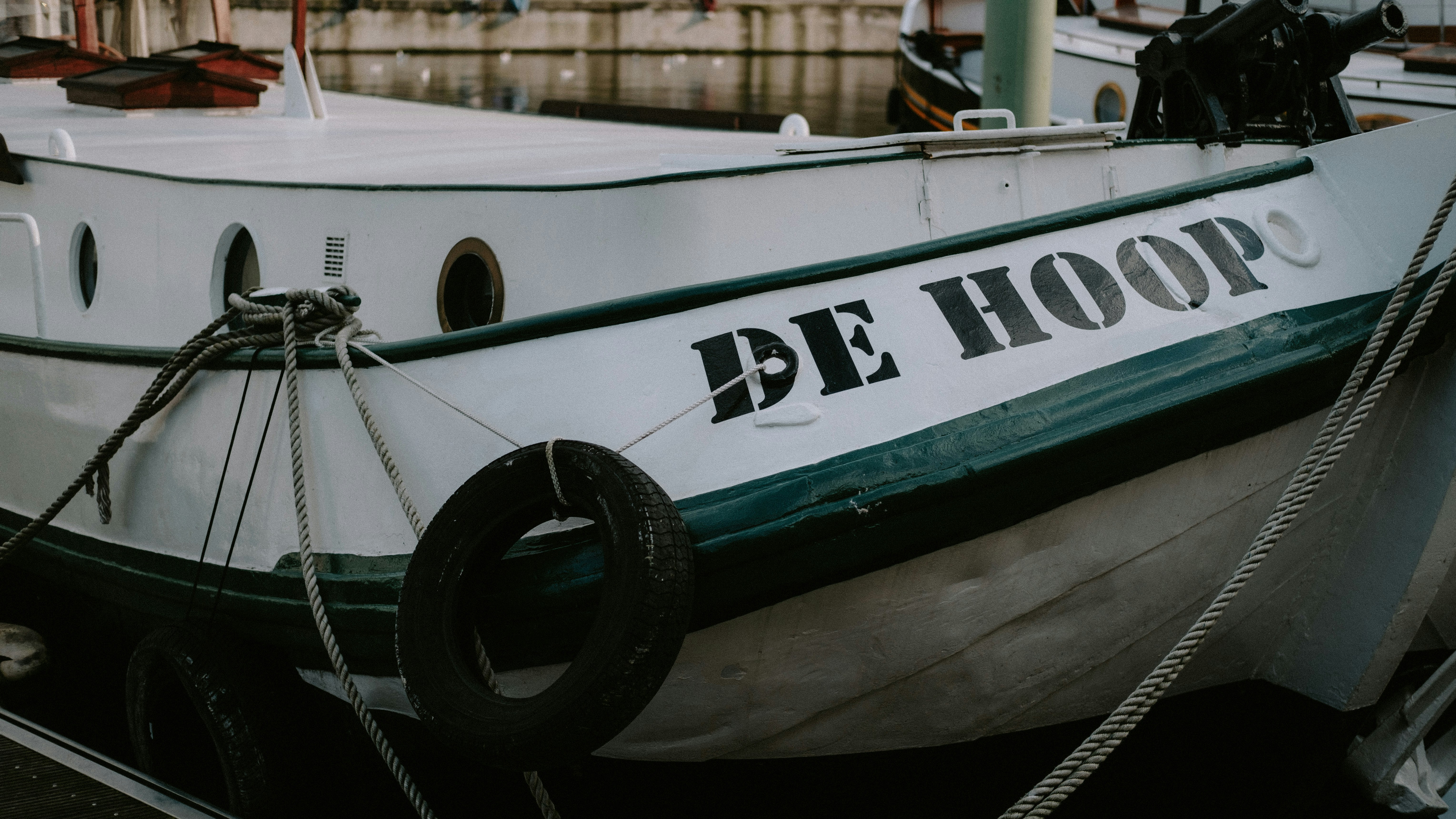 White and green boat showing cabin area for custom lettering