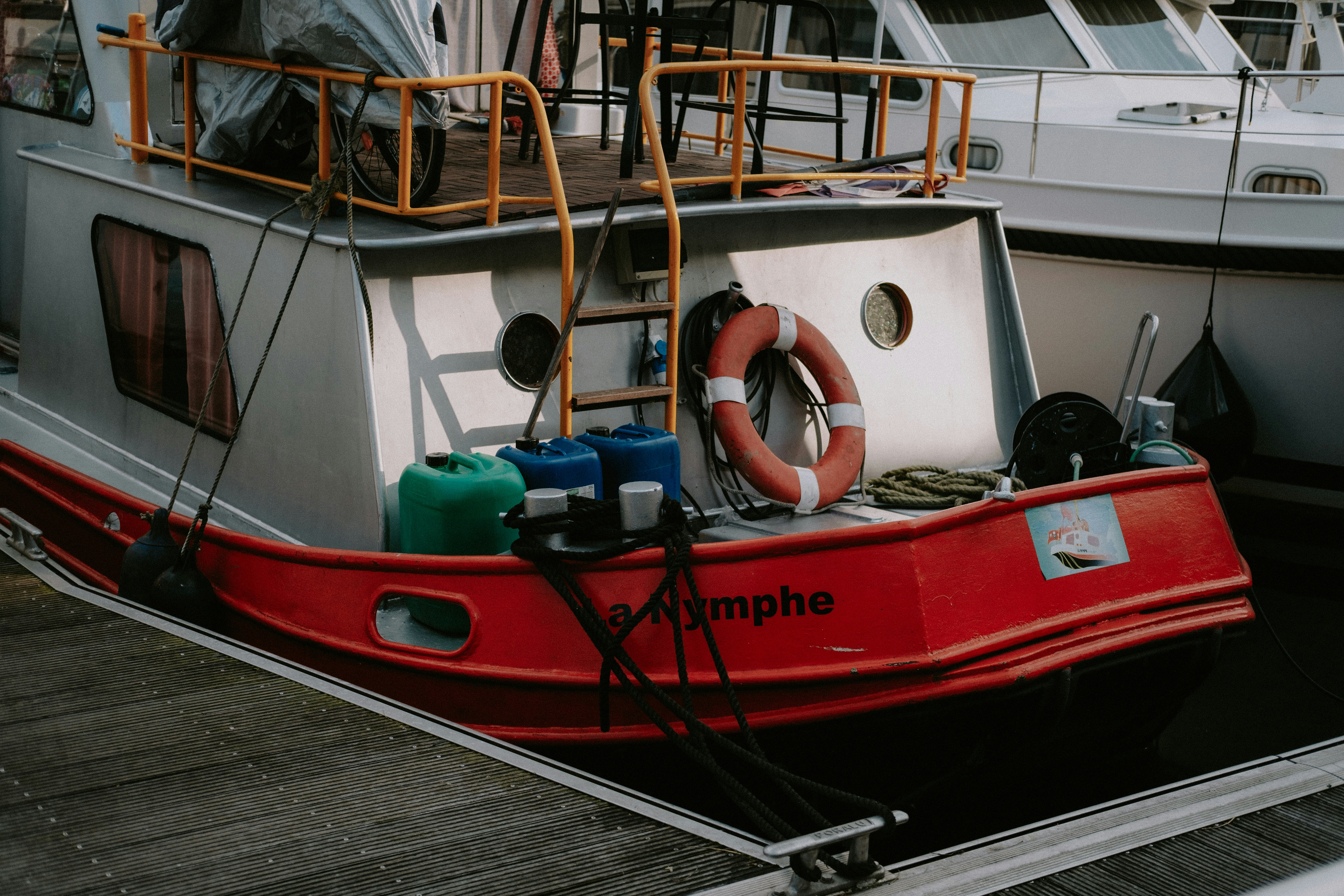 a red and white boat docked at a dock