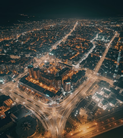 Aerial view of a city skyline with interconnected digital network lines.