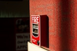a red fire extinguisher on a red wall