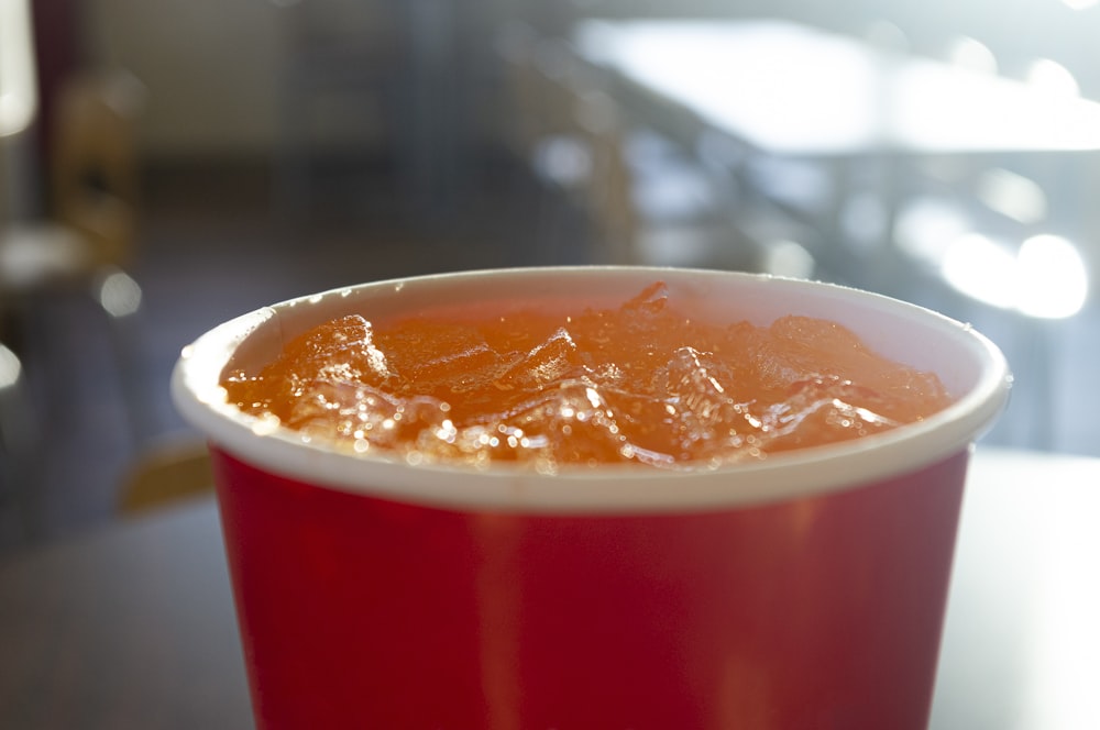 a close up of a cup of liquid on a table