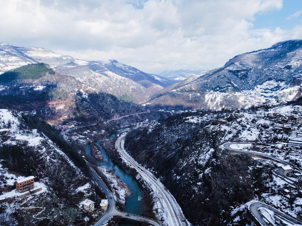 an aerial view of a mountain valley with a river running through it