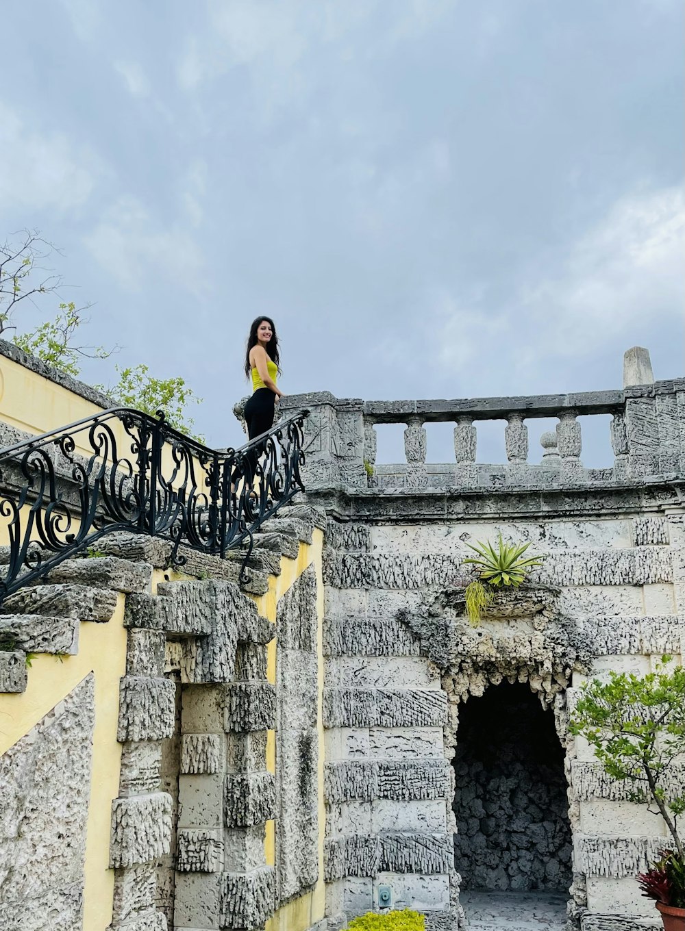 a woman standing on top of a stone building