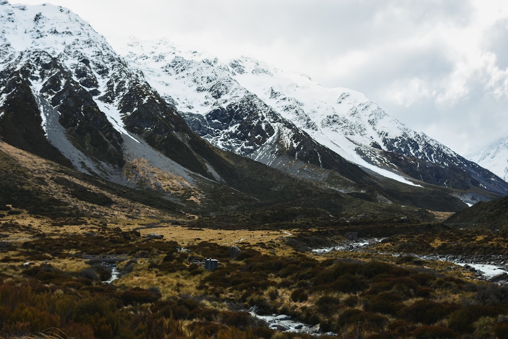 a mountain range with a stream running through it