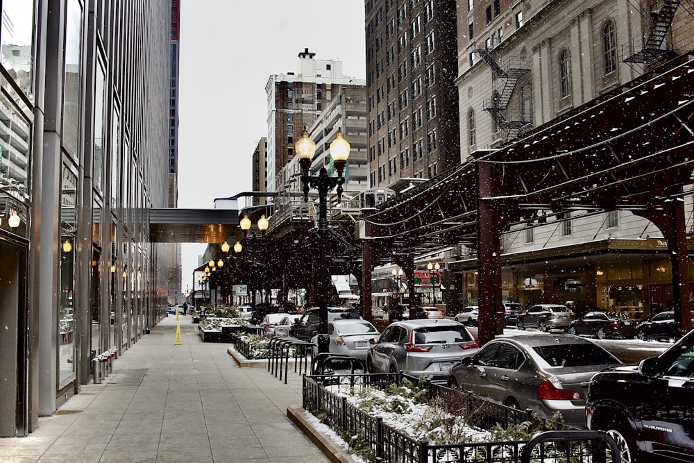 a city street filled with lots of traffic next to tall buildings