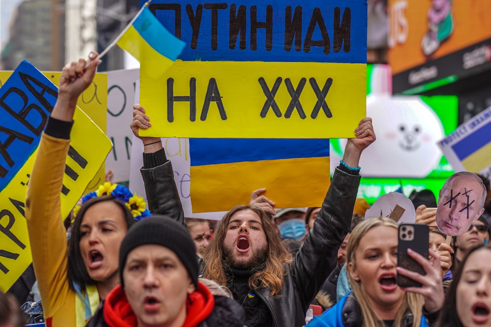 a group of people holding up signs in the air