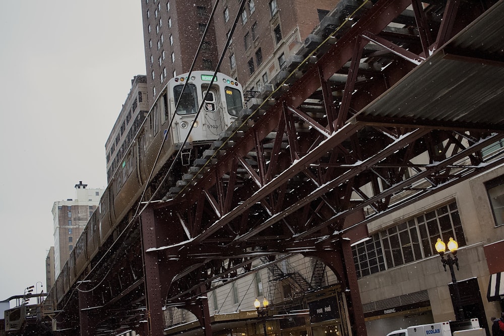 a train is going over a bridge in the snow