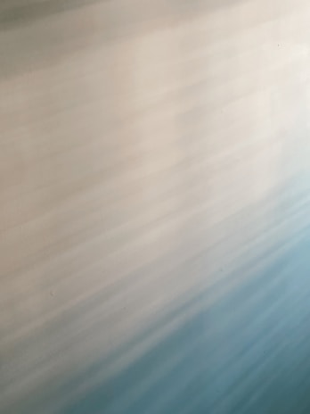 Soft, blended gradient pattern with shades of light blue, cream, and beige creating a calming effect.