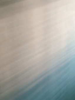 Soft, blended gradient pattern with shades of light blue, cream, and beige creating a calming effect.