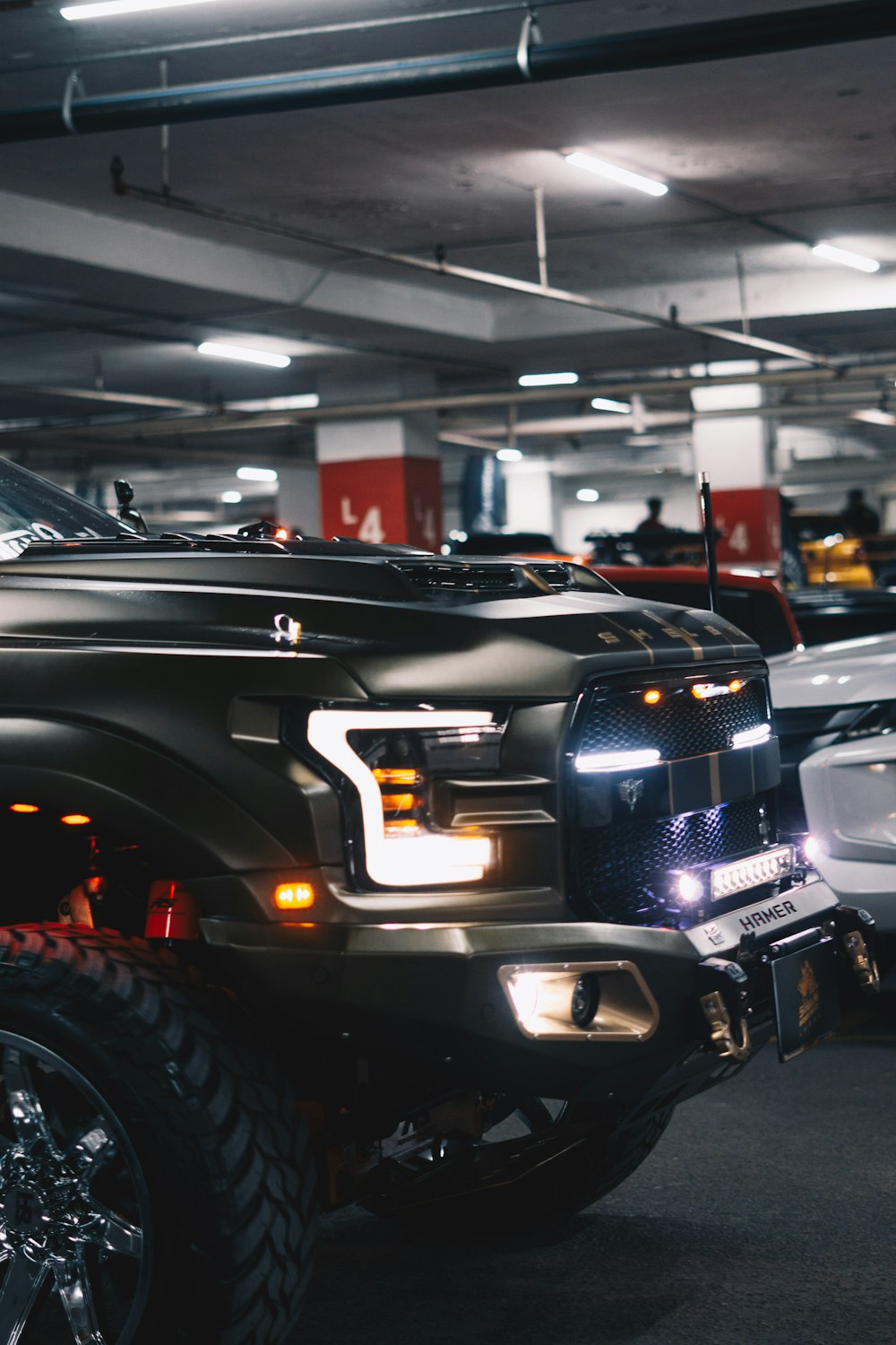 a black truck parked in a parking garage