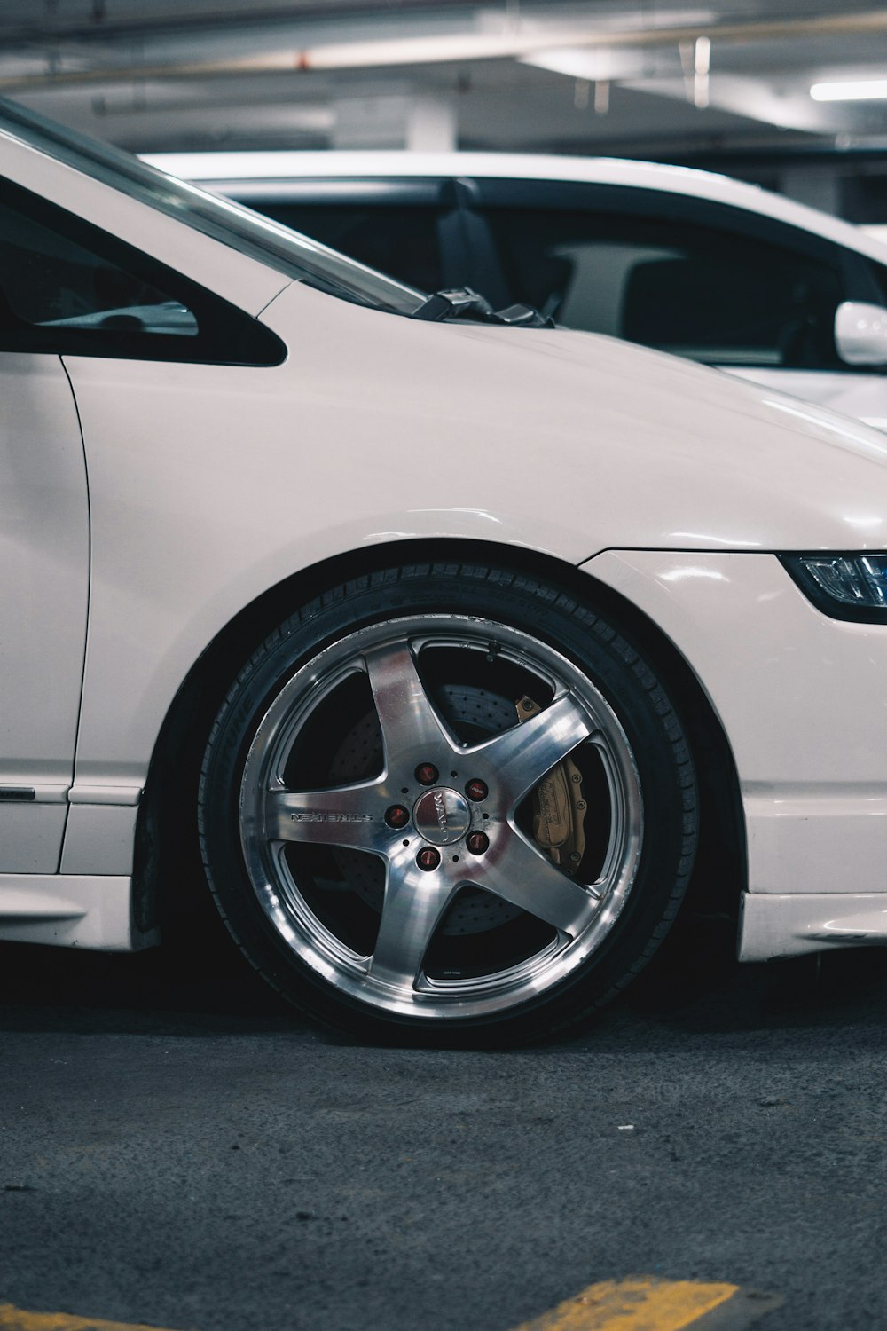 a white car parked in a parking garage