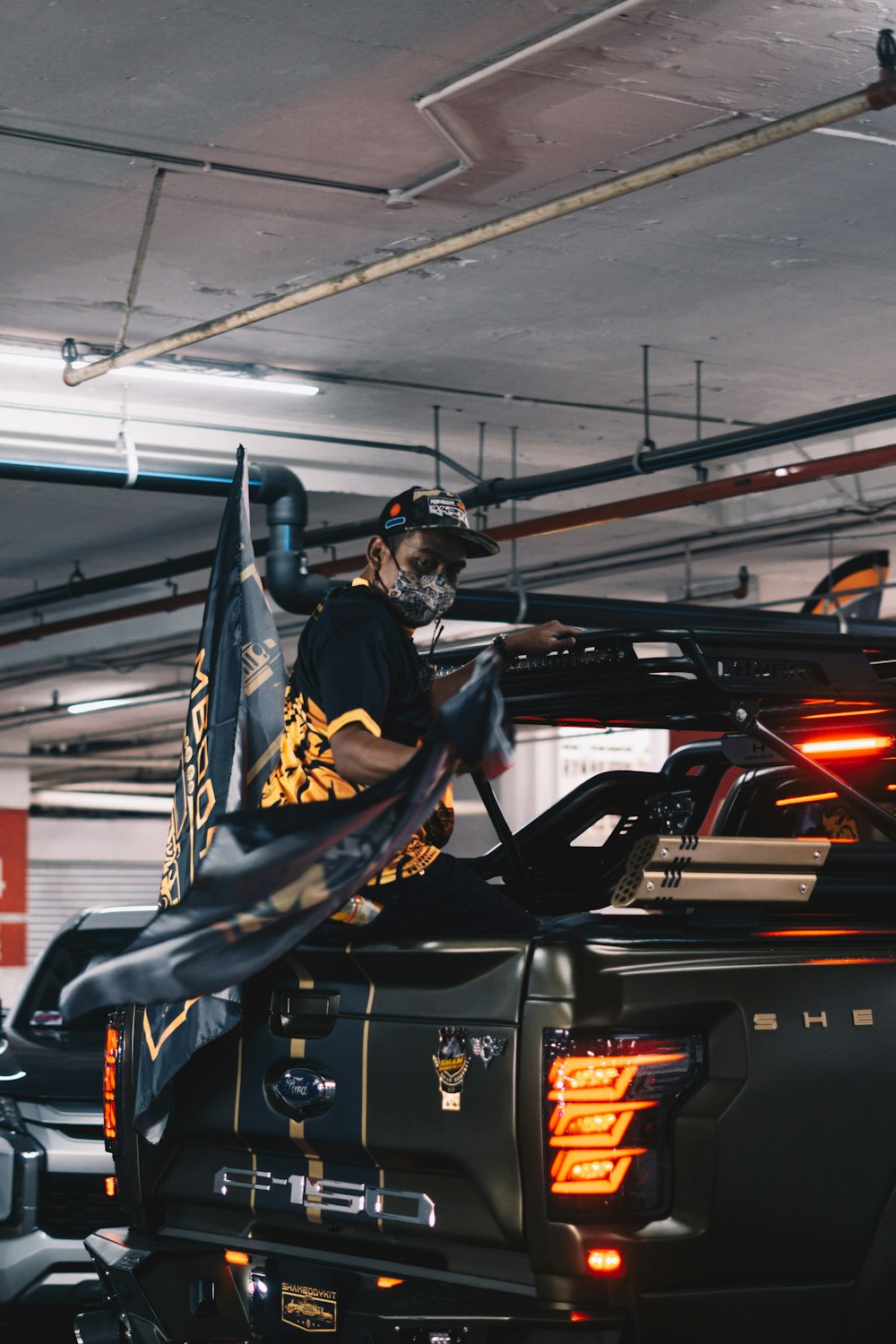 a man on top of a truck in a garage