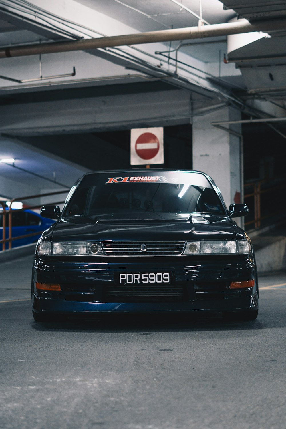 a black car parked in a parking garage