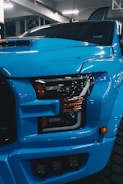 a blue truck is parked in a garage