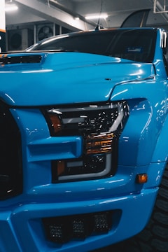 a blue truck is parked in a garage