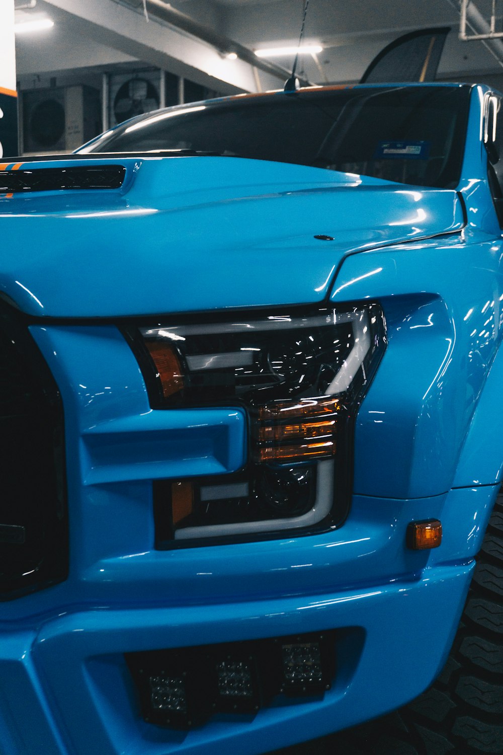 a blue truck is parked in a garage