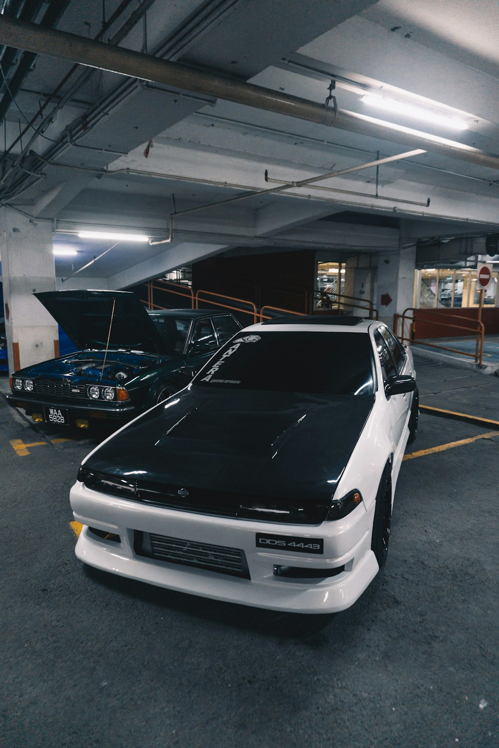 a white car parked in a parking garage